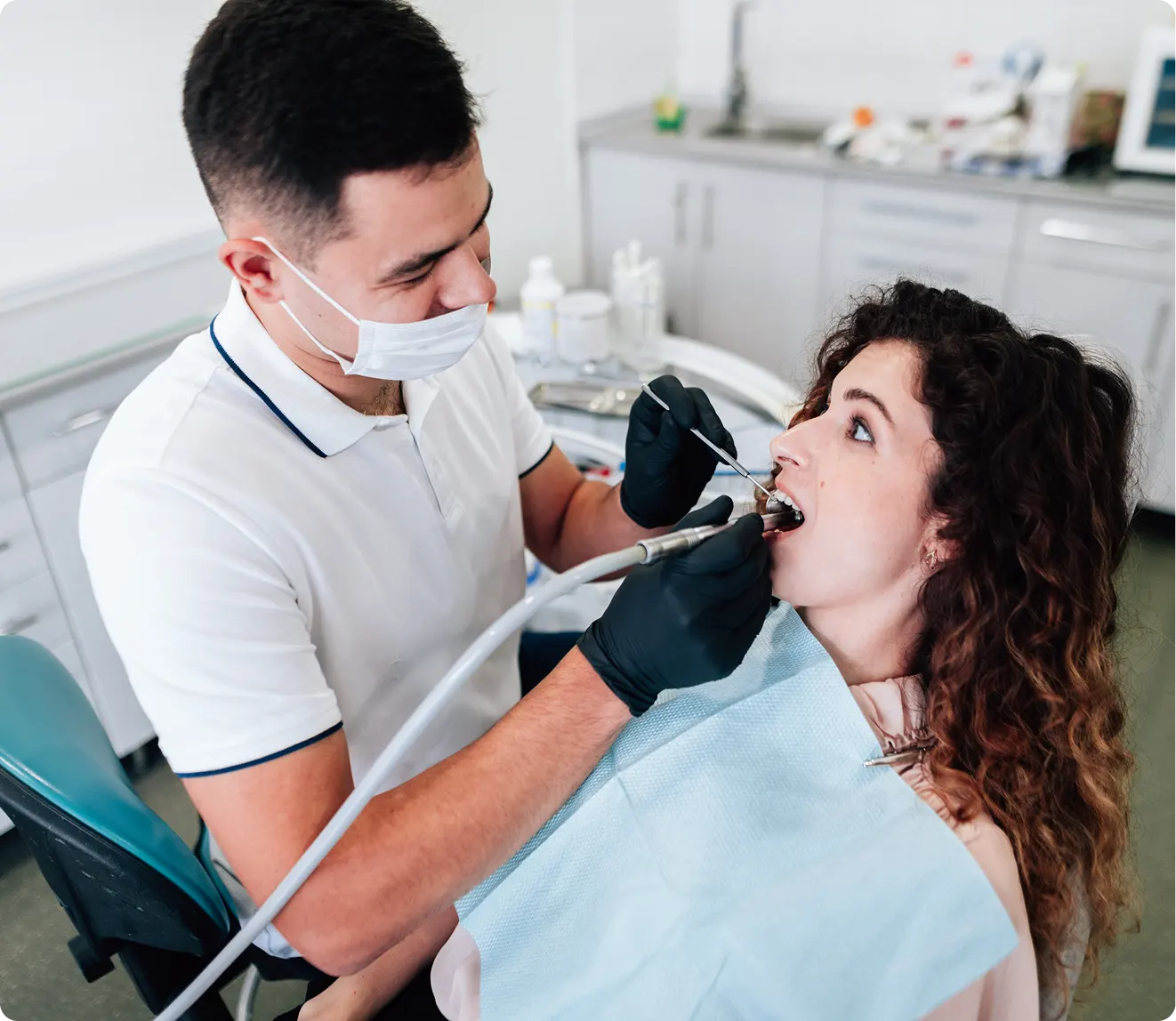 Woman getting her teeth cleaned at dentist