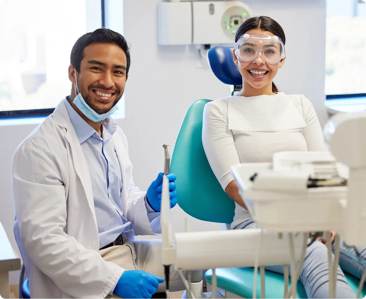 Dentist with patient smiles at dental clinic